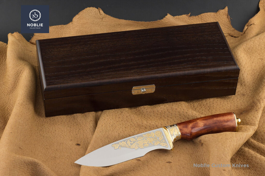 Handmade hunting knife Hunter’s Gift with wooden presentation box on leather surface
