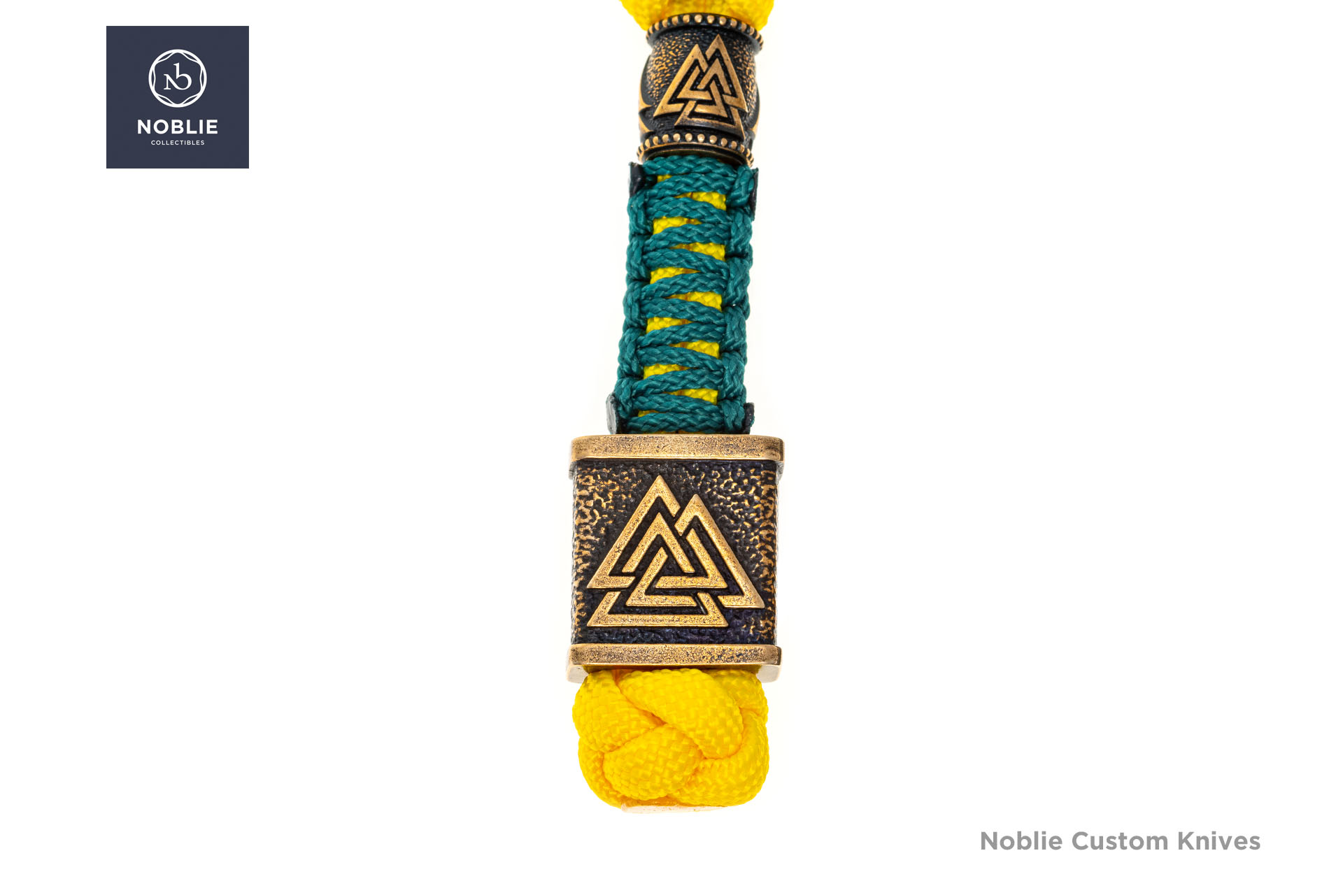 Two bronze beads with interlocking triangle motifs on teal-and-yellow paracord above a yellow stopper knot