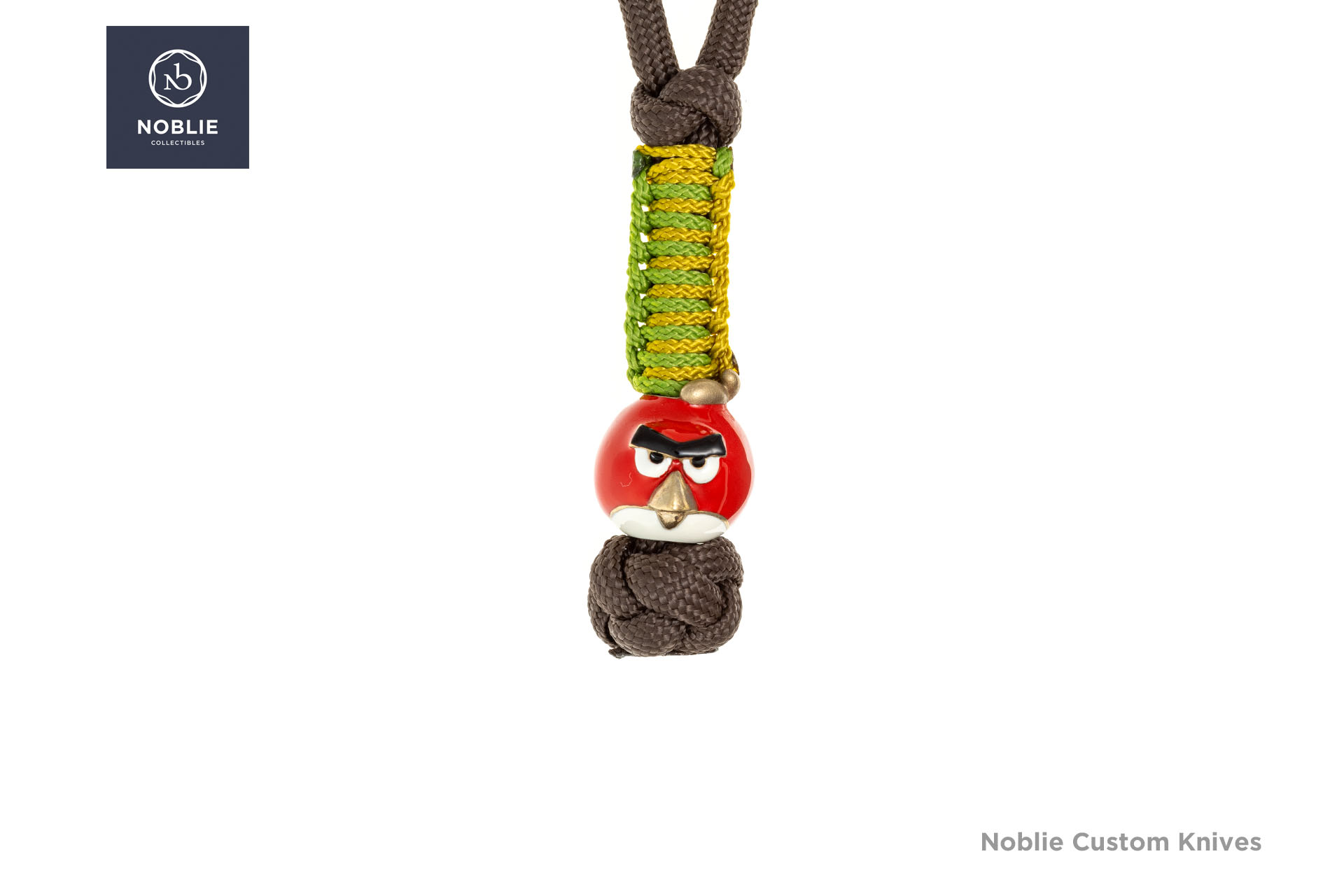 Red Angry Bird bronze bead with white enamel, black eyebrows, and a bronze beak on a green-and-yellow paracord lanyard
