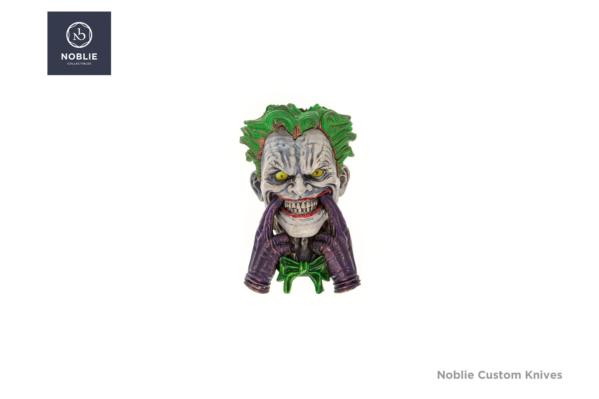 Joker silver paracord bead with yellow glass eyes, green hair, and purple-gloved hands pulling at a toothy grin